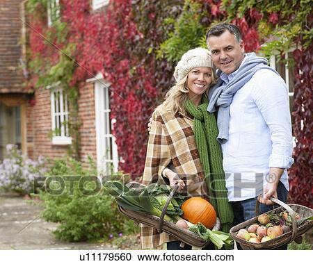 Couple with seasonal vegetables View Large Photo Image Stock Image - Couple with seasonal vegetables. Fotosearch