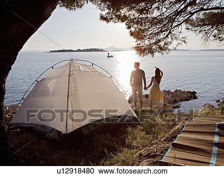 Couple with tent by sea View Large Photo Image Stock Image - Couple with tent by sea. Fotosearch