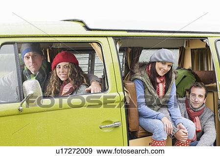 Couples looking out of camper van View Large Photo Image Stock Photo - Couples looking out of camper van. Fotosearch