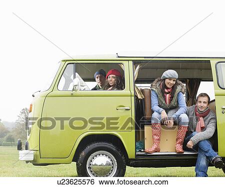 Stock Photograph - Couples looking out of camper van. Fotosearch