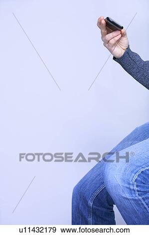 cropped shot of a man checking his phone View Large Photo Image Stock Photo - cropped shot of a man checking his phone. Fotosearch