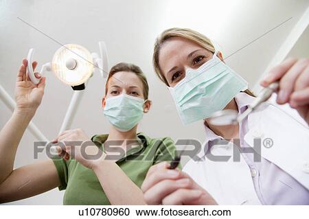 Dentist and dental technician in surgery View Large Photo Image Stock Image - Dentist and dental technician in surgery. Fotosearch