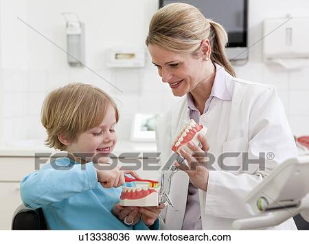 Dentist with boy in surgery View Large Photo Image Stock Photograph - Dentist with boy in surgery. Fotosearch