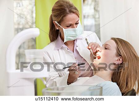 Dentist with patient in surgery View Large Photo Image Stock Image - Dentist with patient in surgery. Fotosearch