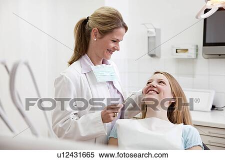Dentist with patient in surgery View Large Photo Image Stock Photography - Dentist with patient in surgery. Fotosearch