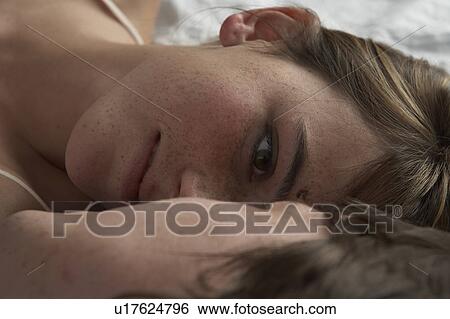 Detail of young couple lying on bed View Large Photo Image Stock Photograph - Detail of young couple lying on bed. Fotosearch