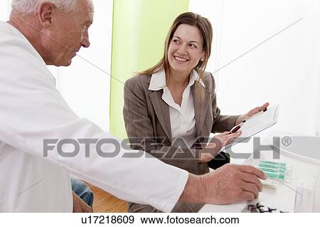 Stock Photo - Doctor and businesswoman in surgery. Fotosearch