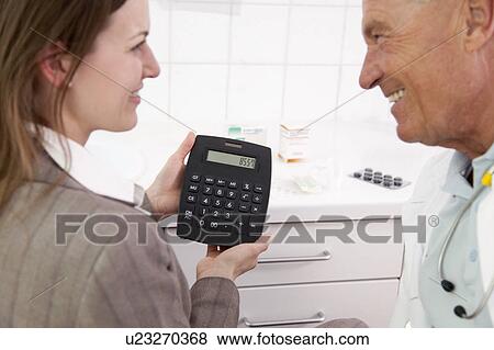 Stock Photo - Doctor and businesswoman in surgery. Fotosearch