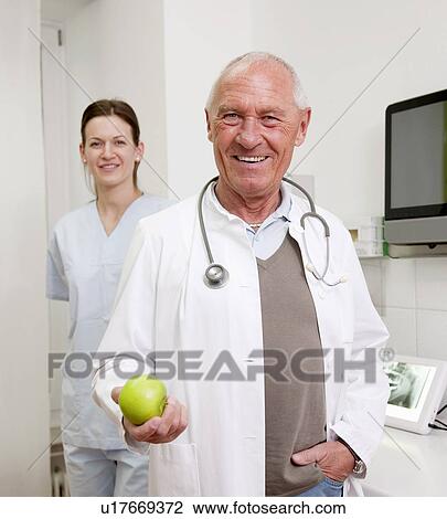 Stock Image - Doctor and nurse in surgery. Fotosearch