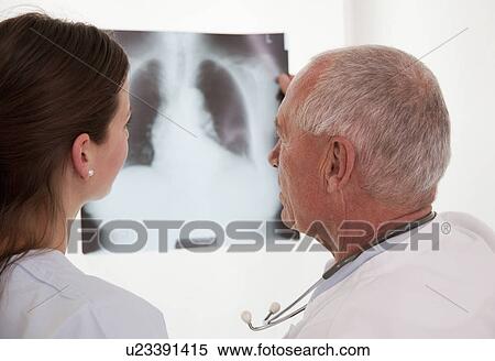Doctor and nurse looking at x-ray View Large Photo Image Stock Photography - Doctor and nurse looking at x-ray. Fotosearch