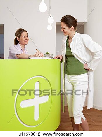 Doctor and receptionist in surgery View Large Photo Image Stock Image - Doctor and receptionist in surgery. Fotosearch