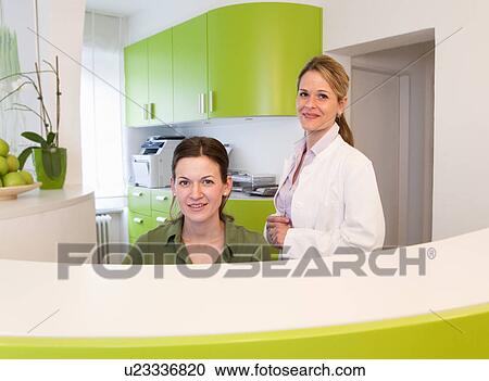 Doctor and receptionist in surgery View Large Photo Image Stock Image - Doctor and receptionist in surgery. Fotosearch