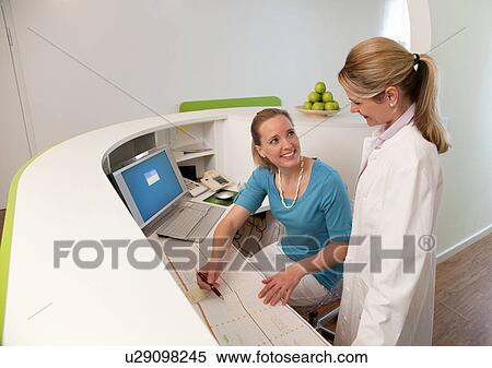 Doctor and Receptionist in surgery View Large Photo Image Stock Photography - Doctor and Receptionist in surgery. Fotosearch
