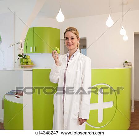 Stock Photo - Doctor eating apple. Fotosearch