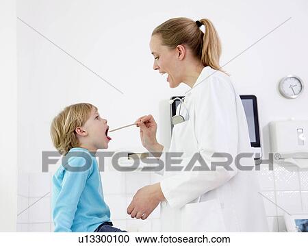 Doctor examining boy View Large Photo Image Stock Image - Doctor examining boy. Fotosearch