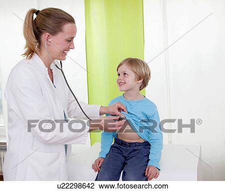 Stock Image - Doctor examining boy. Fotosearch