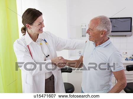 Doctor with patient in surgery View Large Photo Image Stock Photo - Doctor with patient in surgery. Fotosearch