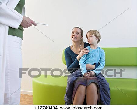Picture - Doctor with patient in waiting area. Fotosearch