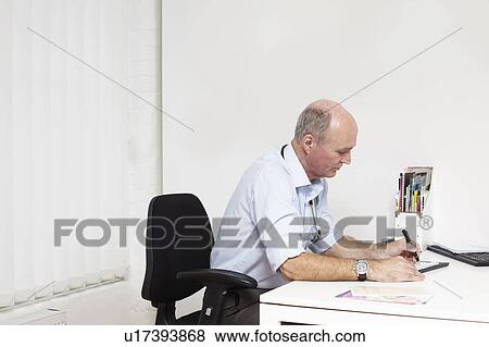 Stock Photo - Doctor working at a desk. Fotosearch