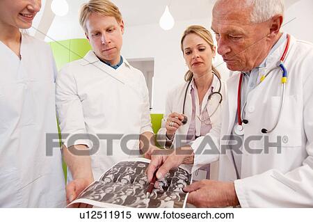 Doctors studying CAT scan View Large Photo Image Stock Photography - Doctors studying CAT scan. Fotosearch