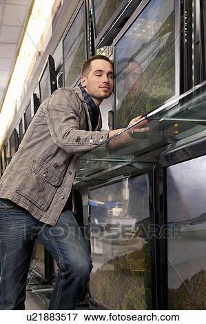 Stock Photo - Dreaming of a new flatscreen television. Fotosearch