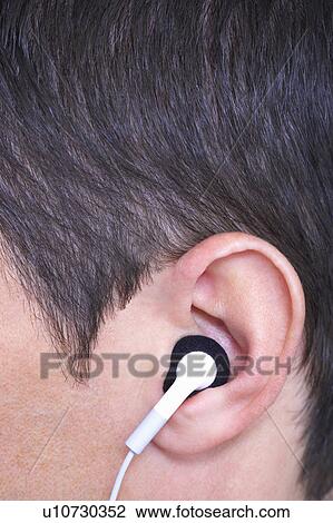 Stock Image - ear with in ear headphone. Fotosearch