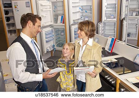 Employee satisfies customers of a cooker View Large Photo Image Stock Photograph - Employee satisfies customers of a cooker. Fotosearch