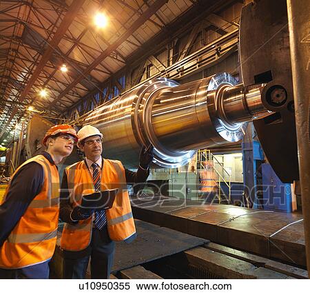 Stock Photography - Engineer & Apprentice With Steel Roller. Fotosearch