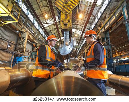 Stock Photo - Engineer & Apprentice With Steel Rollers. Fotosearch