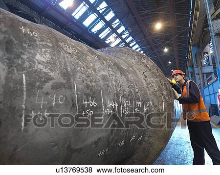 Stock Photo - Engineer Inspecting Forged Steel. Fotosearch
