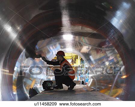 Stock Photo - Engineer Testing Forged Steel. Fotosearch