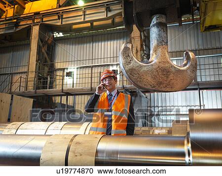 Stock Image - Engineer With Finished Steel Rollers. Fotosearch