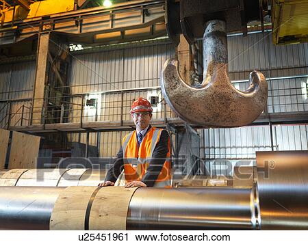 Stock Image - Engineer With Finished Steel Rollers. Fotosearch
