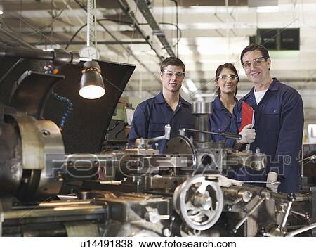 Stock Photo - Engineer With Male & Female Apprentices. Fotosearch