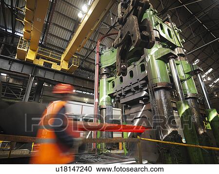 Stock Image - Engineer With Steel Forging Machine. Fotosearch