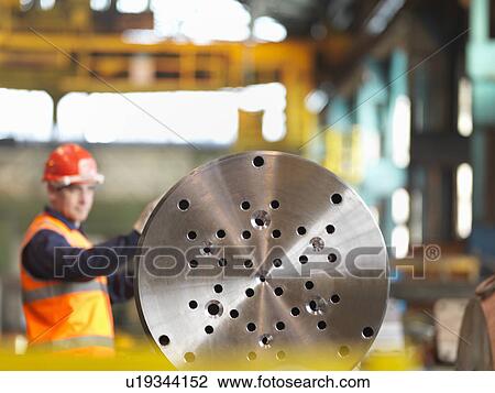 Stock Image - Engineer Working With Steel Part. Fotosearch