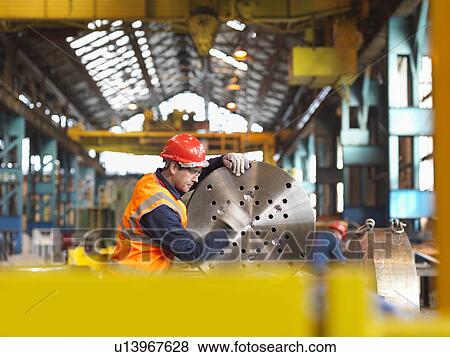 Stock Photo - Engineer Working With Steel Part. Fotosearch