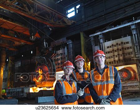 Picture - Engineers & Hot Steel In Forging Machine. Fotosearch