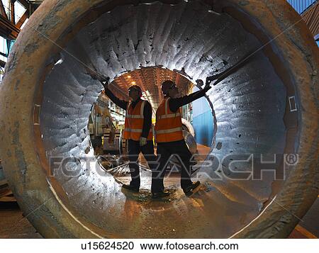Stock Image - Engineers Inspecting Forged Steel. Fotosearch