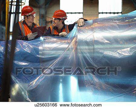 Stock Photograph - Engineers Inspecting Steel For Dispatch. Fotosearch