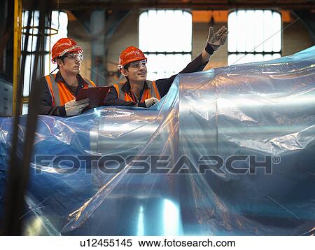 Stock Photography - Engineers Inspecting Steel For Dispatch. Fotosearch