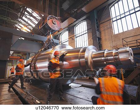 Stock Image - Engineers With Finished Steel Product. Fotosearch