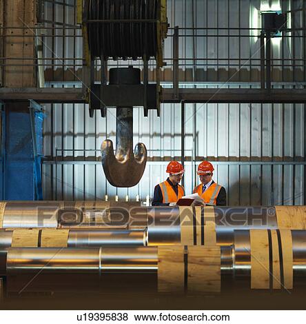 Stock Photo - Engineers With Finished Steel Rollers. Fotosearch