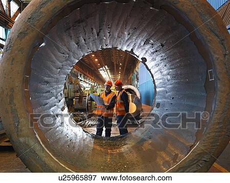 Engineers With Plans And Forged Steel View Large Photo Image Stock Photo - Engineers With Plans And Forged Steel. Fotosearch
