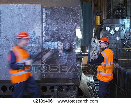 Stock Image - Engineers Working With Forged Steel. Fotosearch