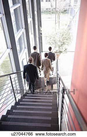 Stock Photograph - Executives walking downstairs. Fotosearch