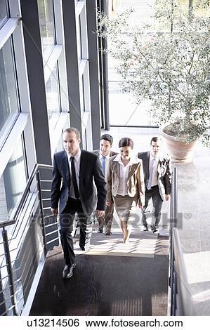 Stock Photograph - Executives walking upstairs. Fotosearch