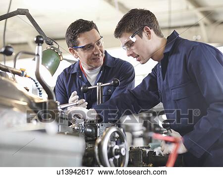 Experienced Engineer Teaching Apprentice View Large Photo Image Stock Photo - Experienced Engineer Teaching Apprentice. Fotosearch