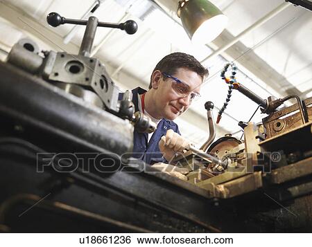 Stock Photograph - Experienced Engineer With Lathe. Fotosearch
