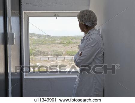 Factory worker looking out of window View Large Photo Image Stock Image - Factory worker looking out of window. Fotosearch
